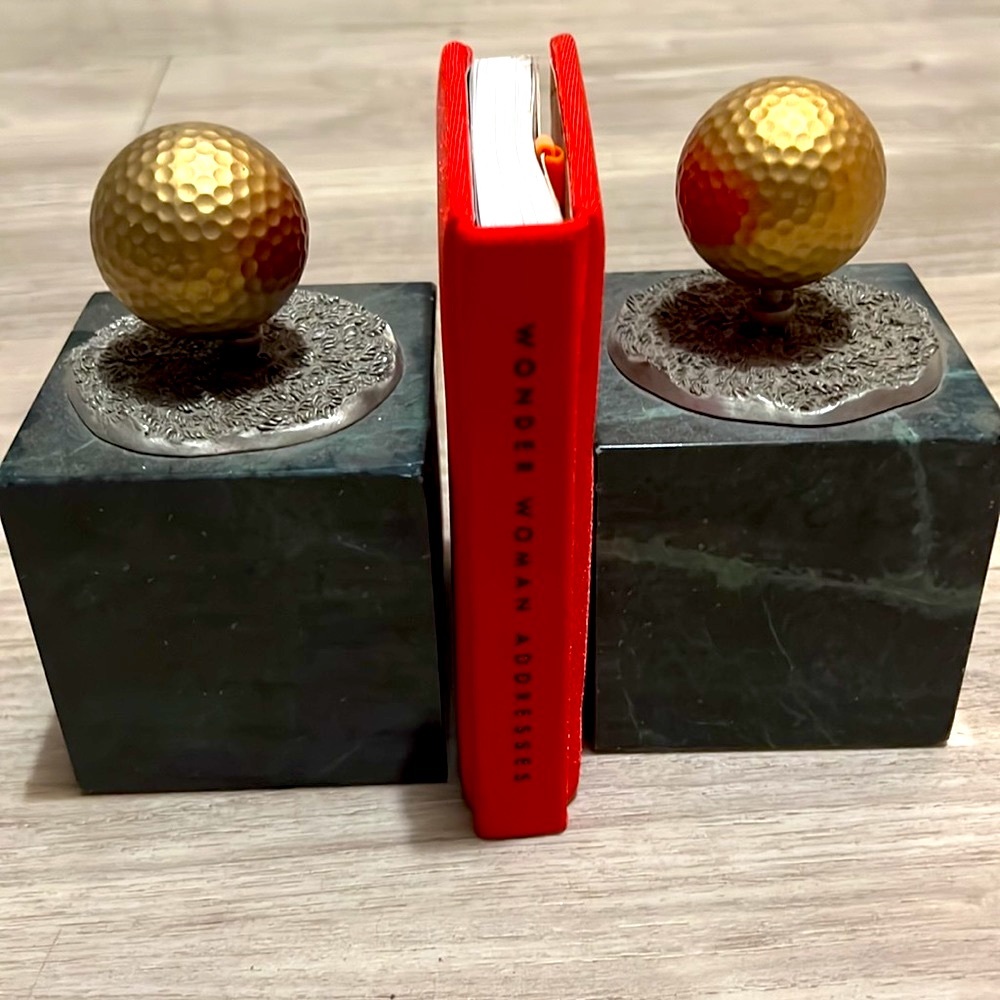 A pair of vintage brass golf ball bookends marble black with grey base Taiwan